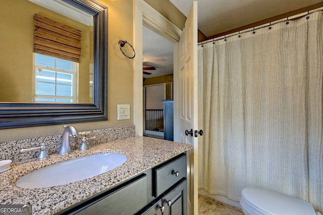 bathroom featuring vanity and toilet