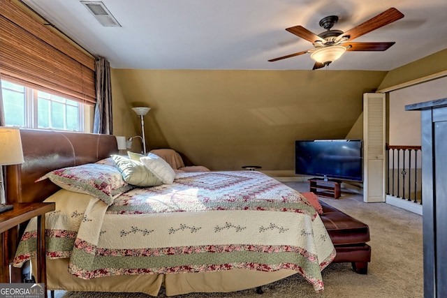 carpeted bedroom with lofted ceiling, a closet, and ceiling fan