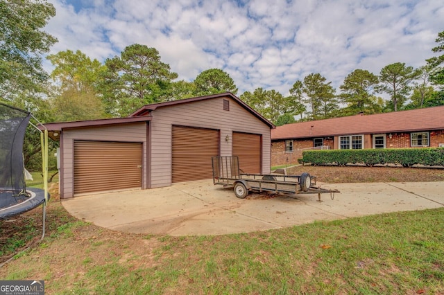 detached garage featuring a trampoline