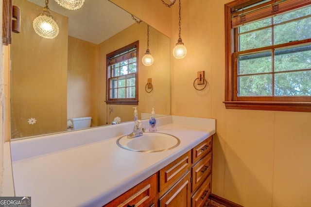 bathroom featuring vanity and toilet