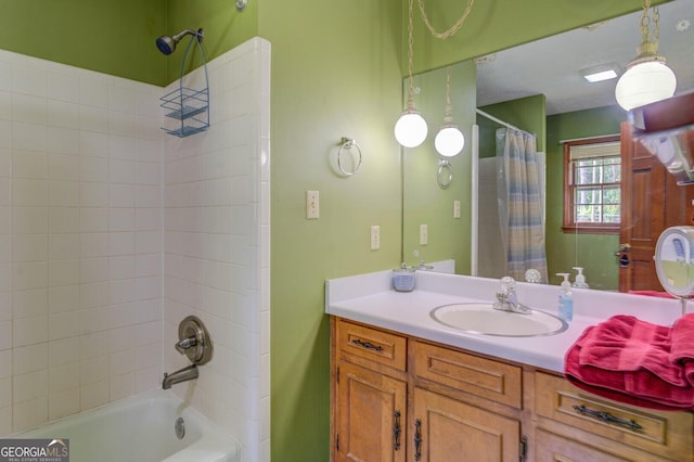 bathroom featuring shower / bath combo with shower curtain and vanity