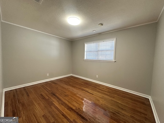 unfurnished room featuring hardwood / wood-style flooring, crown molding, and a textured ceiling