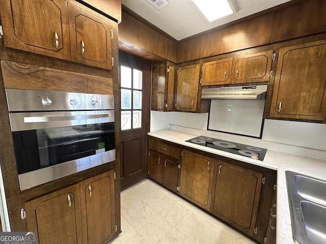 kitchen featuring black electric cooktop, sink, and stainless steel oven