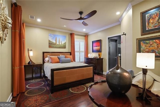 bedroom featuring hardwood / wood-style flooring, ornamental molding, and ceiling fan