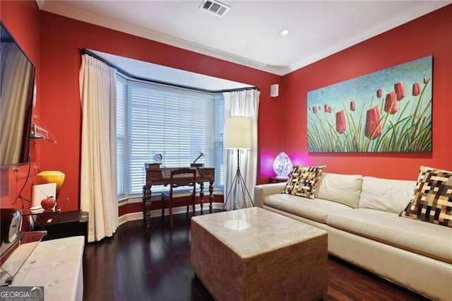 living room with dark hardwood / wood-style flooring and crown molding