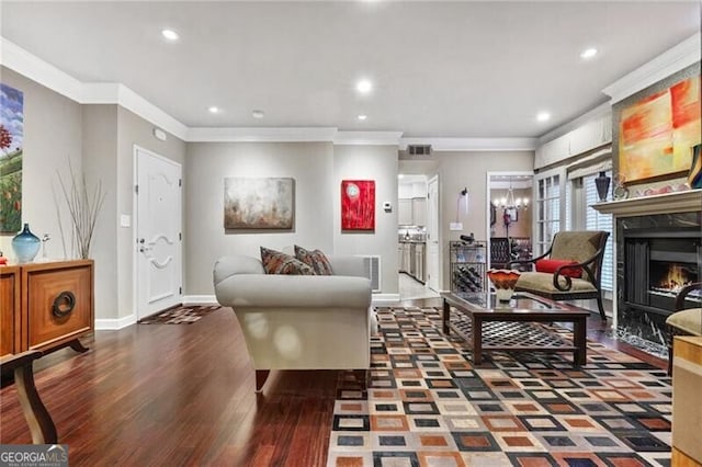 living room with ornamental molding, dark hardwood / wood-style flooring, and a chandelier