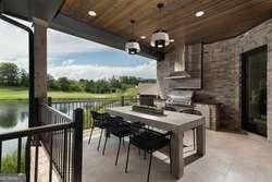 view of patio / terrace with a water view and an outdoor kitchen