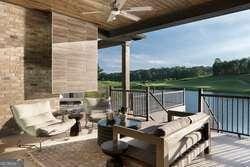 view of patio / terrace with ceiling fan and a fireplace