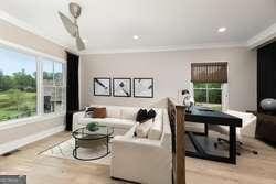 living room featuring ornamental molding and light hardwood / wood-style floors