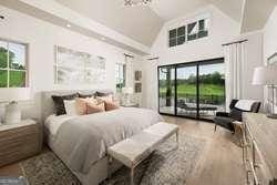 bedroom with lofted ceiling, hardwood / wood-style flooring, and access to outside