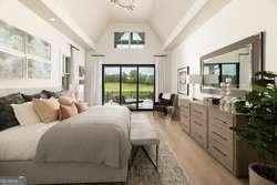 bedroom featuring high vaulted ceiling, access to exterior, and light wood-type flooring