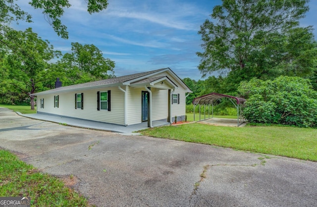 view of front facade with a carport and a front lawn