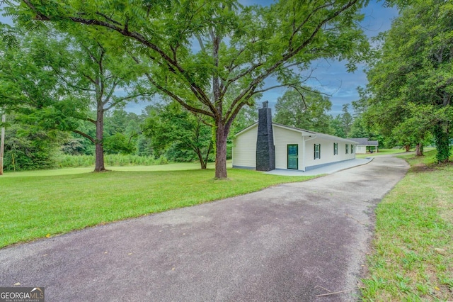 view of side of property featuring a yard