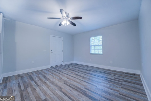 spare room with wood-type flooring and ceiling fan