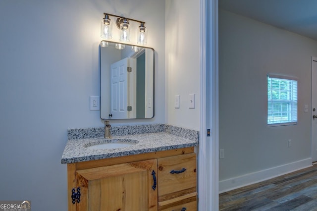 bathroom featuring hardwood / wood-style flooring and vanity