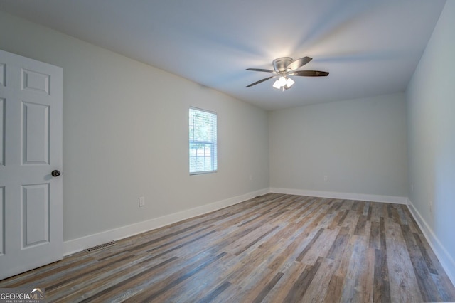 spare room featuring light hardwood / wood-style flooring and ceiling fan