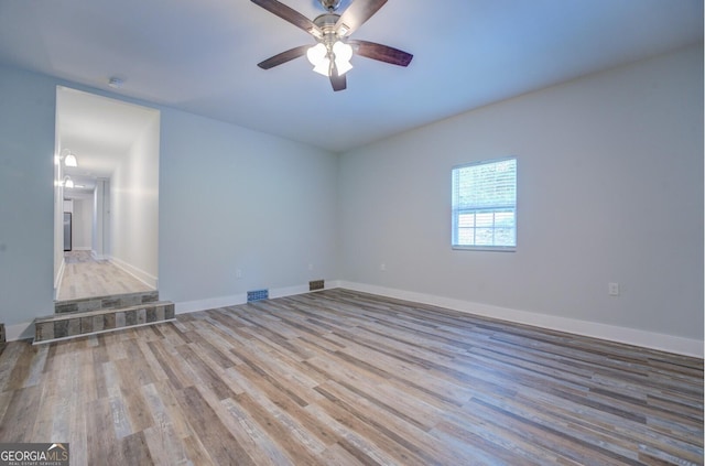 spare room featuring ceiling fan and light wood-type flooring