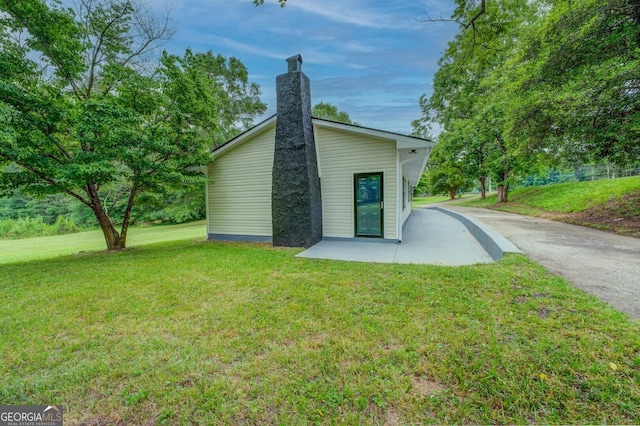 rear view of property with a yard and a patio area