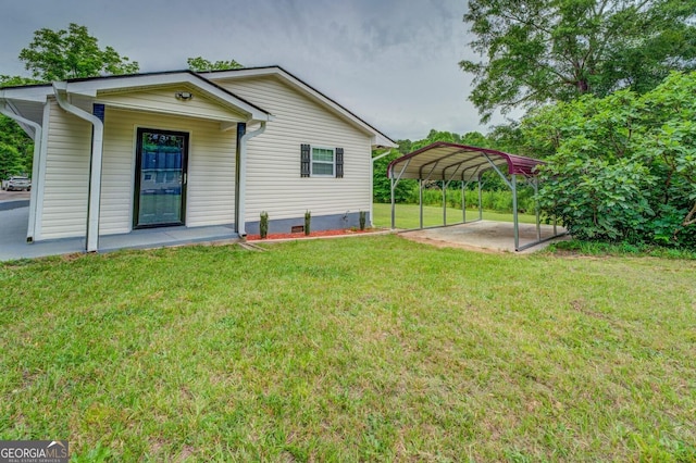 back of house with a lawn and a carport