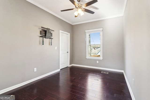 unfurnished room with dark wood-type flooring, ornamental molding, and ceiling fan