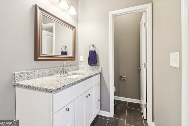 bathroom featuring tile patterned flooring, vanity, and toilet