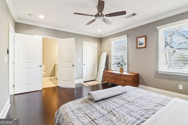 bedroom featuring crown molding, dark wood-type flooring, connected bathroom, and ceiling fan