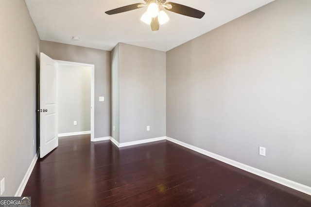 empty room with dark wood-type flooring and ceiling fan