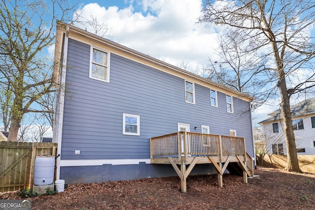 back of property featuring a wooden deck