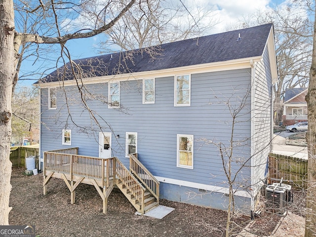 rear view of property featuring a wooden deck and central air condition unit