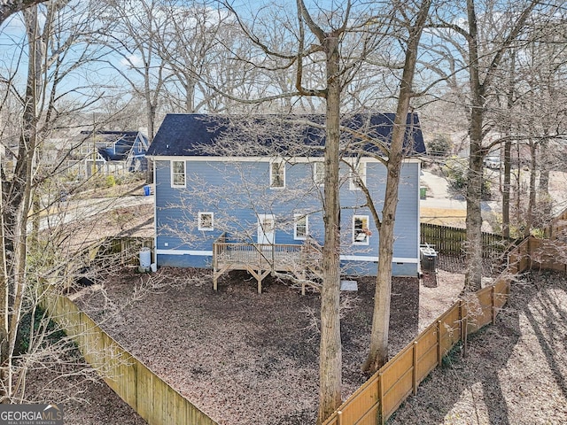 rear view of property with central AC unit