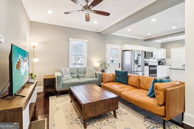 living room with beamed ceiling, ceiling fan, ornamental molding, and light hardwood / wood-style flooring