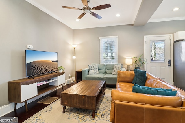 living room featuring crown molding, plenty of natural light, and dark hardwood / wood-style flooring