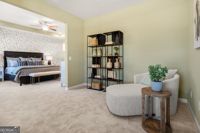 sitting room featuring ceiling fan and light carpet