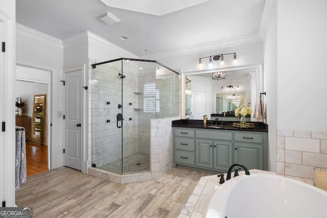 bathroom with hardwood / wood-style flooring, crown molding, and vanity