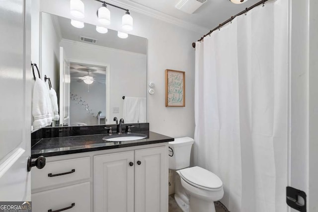 bathroom featuring crown molding, vanity, and toilet