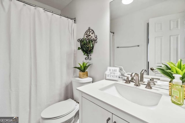 bathroom featuring vanity and toilet