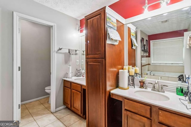 bathroom featuring toilet, a textured ceiling, vanity, a bath, and tile patterned flooring