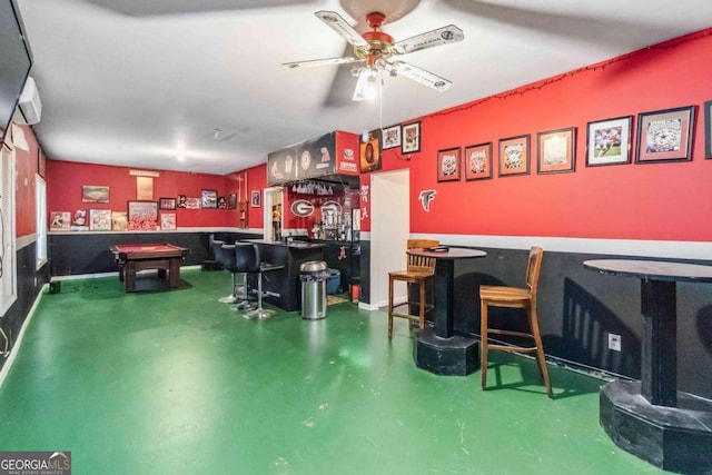 bar featuring concrete flooring and ceiling fan