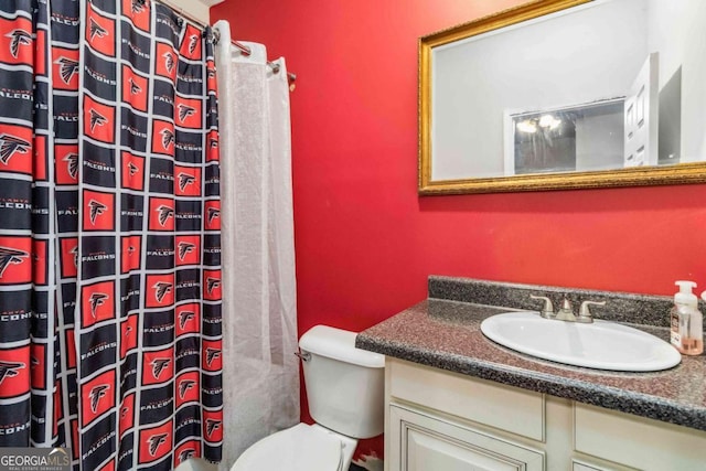 bathroom with vanity, curtained shower, and toilet