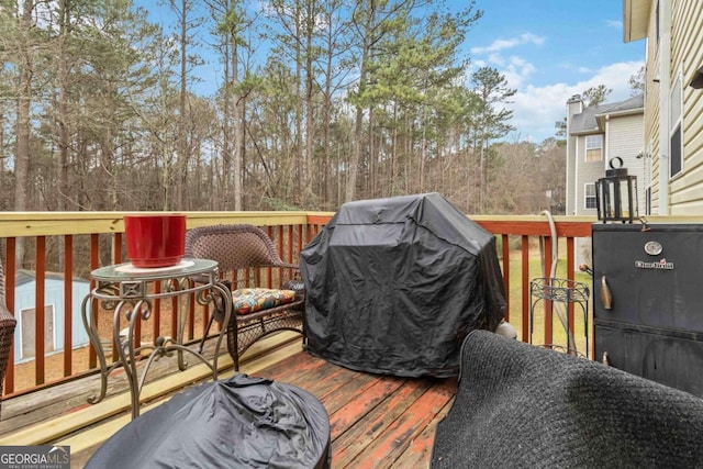 wooden terrace with area for grilling