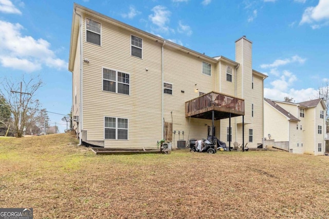 back of property with a yard and a deck