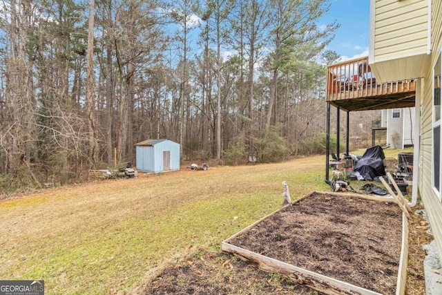 view of yard featuring a wooden deck and a storage shed