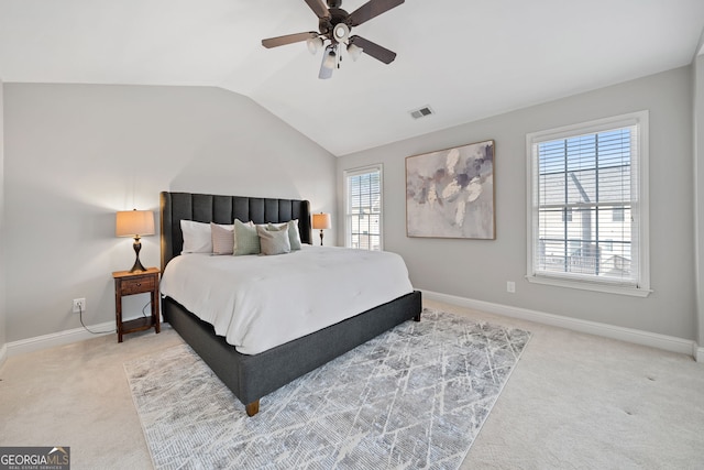 carpeted bedroom featuring vaulted ceiling, a ceiling fan, visible vents, and baseboards