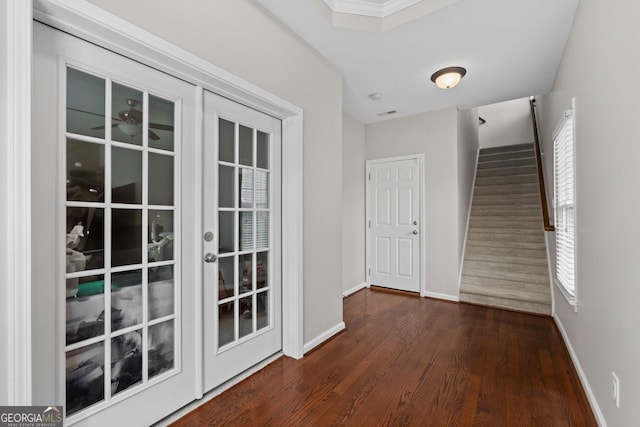 entryway with wood finished floors, a healthy amount of sunlight, baseboards, and stairs