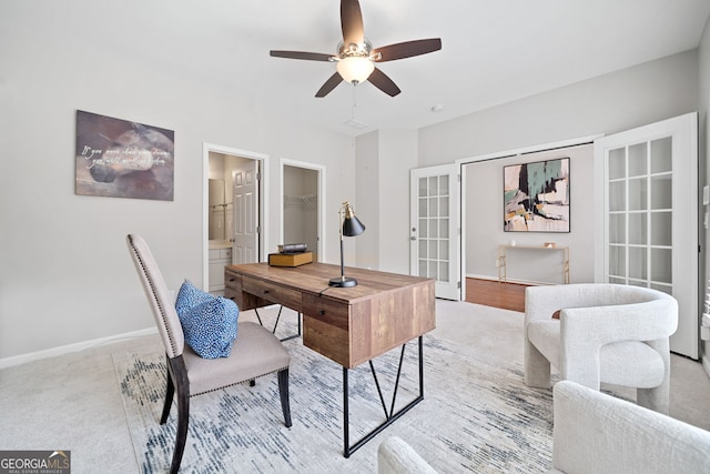 carpeted office space featuring a ceiling fan, french doors, and baseboards