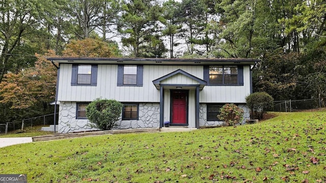 raised ranch with a front lawn