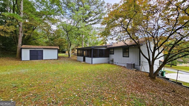 view of yard with cooling unit, a sunroom, and a shed