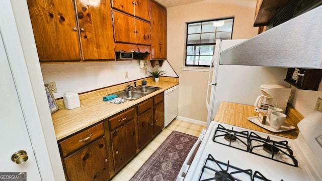 kitchen featuring sink and white appliances