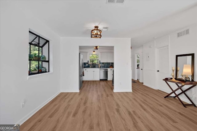 unfurnished living room featuring light wood-type flooring