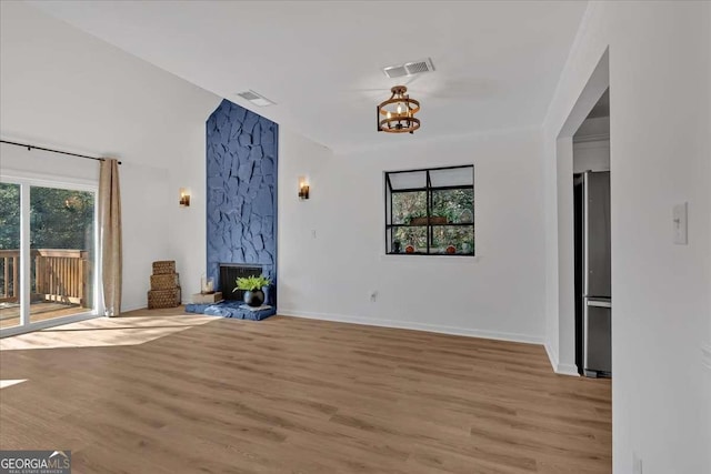 unfurnished living room with a fireplace and light hardwood / wood-style floors